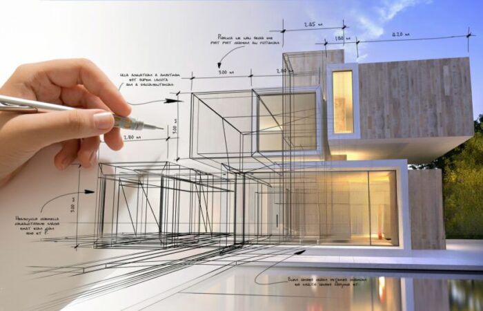 Mão a desenhar um projecto a simbolizar o licenciamento urbanístico