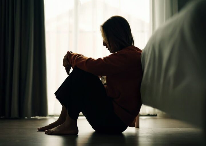 Mulher sentada no chão a pensar na separação